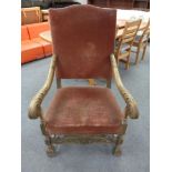 A 20th century carved oak framed high backed armchair