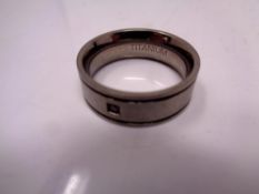 A titanium gent's band ring set with a stone
