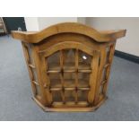 An oak single door wall cabinet