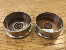 A pair of silver wine coasters, London marks, diameter 9.
