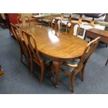 An oval American style extending dining table and six chairs