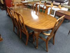 An oval American style extending dining table and six chairs