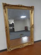 An ornate gilt framed over mantle mirror