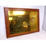 A brass Elswick Public Baths and Wash Houses plaque mounted to board