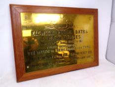 A brass Elswick Public Baths and Wash Houses plaque mounted to board