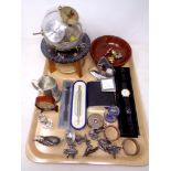 A tray of plated napkin rings, pewter figures, boxed pens, watch,