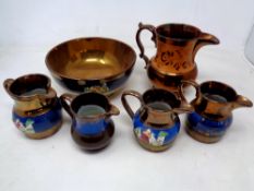 Five antique copper lustre jugs together with a bowl