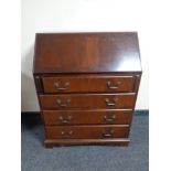 A mahogany bureau fitted with four drawers