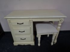 A contemporary cream single pedestal dressing table with similar footstool