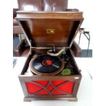 An oak cased HMV gramophone with a quantity of records
