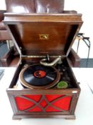 An oak cased HMV gramophone with a quantity of records