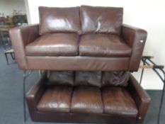 A contemporary brown leather three seater and two seater settee