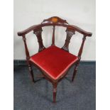 A corner armchair with red dralon seats