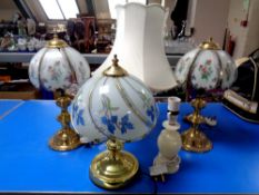 Three brass table lamps with glass shades together with two further lamps (one with shade).