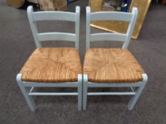 A pair of painted child's rush seated chairs