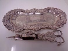 A silver plated tray with candle snuffer on copper