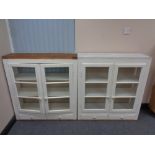 A pair of antique pine painted double door wall cabinets fitted with drawers