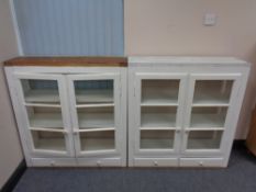 A pair of antique pine painted double door wall cabinets fitted with drawers