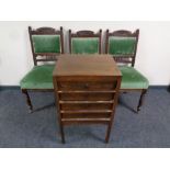 An Edwardian four drawer music chest on raised feet and three Edwardian chairs