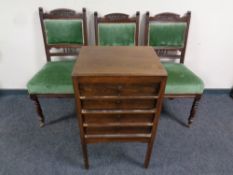 An Edwardian four drawer music chest on raised feet and three Edwardian chairs