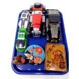 A tray of die cast cars, tin plated money box,