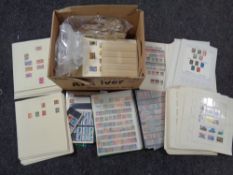 A box of antique and later world stamps, loose and on paper.