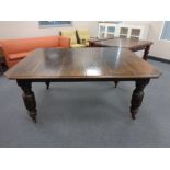 A 19th century oak wind out table with extension leaf and table winder together with a set of six