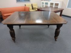 A 19th century oak wind out table with extension leaf and table winder together with a set of six