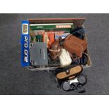 A box of cased binoculars, Remington shaver, board games, vintage cameras,