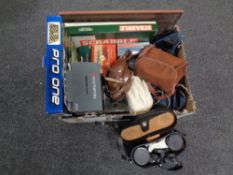 A box of cased binoculars, Remington shaver, board games, vintage cameras,