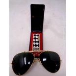 A pair of Rayban aviator sunglasses together with a Ronson butane lighter in box