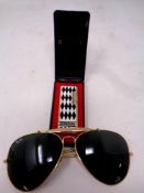 A pair of Rayban aviator sunglasses together with a Ronson butane lighter in box