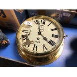 A brass cased Smiths Astral brass cased ship's clock with key,