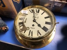 A brass cased Smiths Astral brass cased ship's clock with key,
