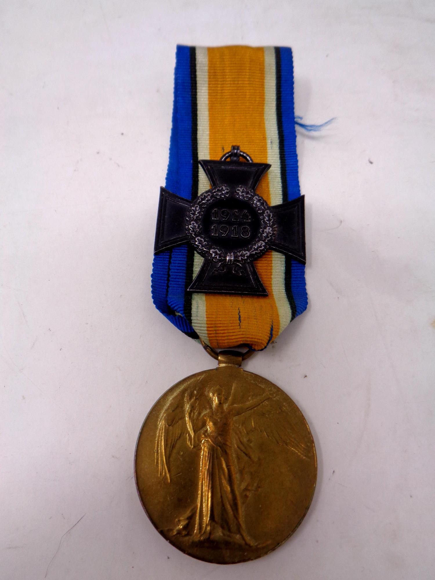 A WWI Victory Medal awarded to A.R. Sword together with a German 1914-18 cross.