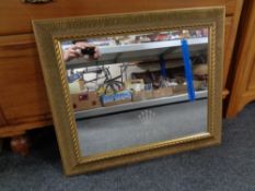 A gilt framed mirror bearing Rolex advertising