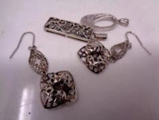 Two silver pendants with earrings