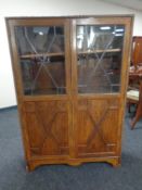 An Edwardian leaded glass double door cabinet