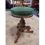 A Victorian carved mahogany revolving stool on tripod base