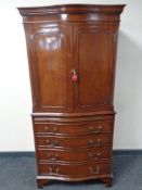 A reproduction mahogany serpentine fronted drinks cabinet