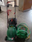 A Qualcast easitrax 320 electric lawn mower with grass box and lead together with a hozelock hose