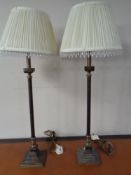 A pair of contemporary bronzed table lamps with tassel shades