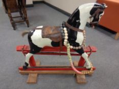 An early twentieth century painted wooden rocking horse