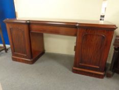 A Victorian mahogany inverted break fronted pedestal sideboard