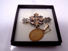 A 10ct gold disc pendant and an antique silver bar brooch