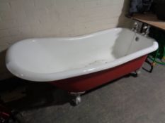 A Victorian style roll topped bath with taps