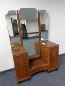 An Art Deco walnut sunk centre dressing table with triple mirror back