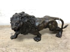 A cast bronze figure of a lion, length 31 cm.