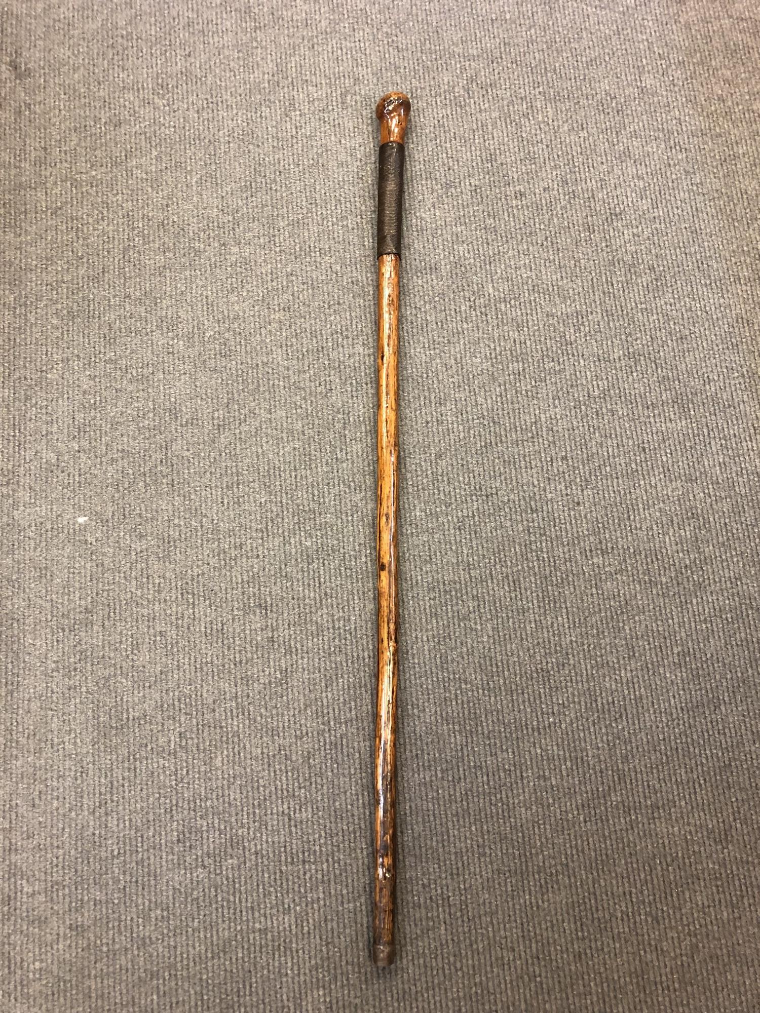 An early 20th century sword cane, with coin-inset pommel revealing a 15cm blade.