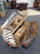 A box containing HMS Endeavour modelling kit in box, two further part built model boats,